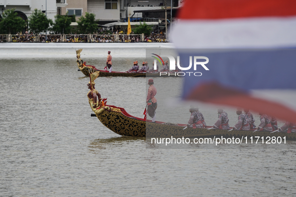 Thai oarsmen in traditional costume row during the Royal Barge Procession for the Royal Kathin ceremony along the Chao Phraya River in Bangk...