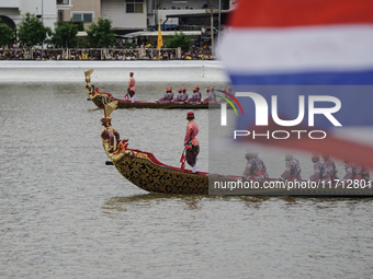 Thai oarsmen in traditional costume row during the Royal Barge Procession for the Royal Kathin ceremony along the Chao Phraya River in Bangk...