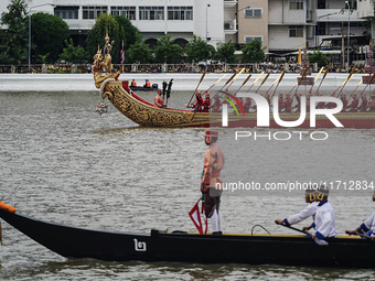 Thai oarsmen in traditional costume row during the Royal Barge Procession for the Royal Kathin ceremony along the Chao Phraya River in Bangk...