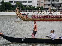 Thai oarsmen in traditional costume row during the Royal Barge Procession for the Royal Kathin ceremony along the Chao Phraya River in Bangk...