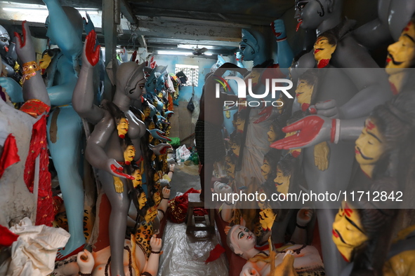 An artist adorns an idol of the Hindu goddess Kali inside a workshop ahead of the Diwali festival in Kolkata, India, on October 27, 2024. Di...