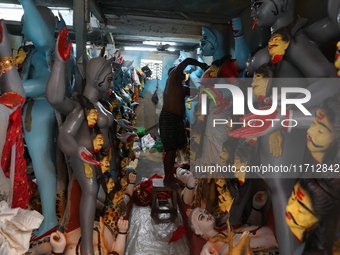 An artist adorns an idol of the Hindu goddess Kali inside a workshop ahead of the Diwali festival in Kolkata, India, on October 27, 2024. Di...