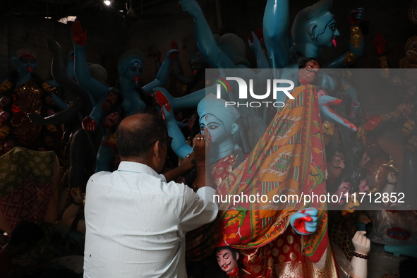 An artist paints an idol of the Hindu goddess Kali inside a workshop ahead of the Diwali festival in Kolkata, India, on October 27, 2024. Di...