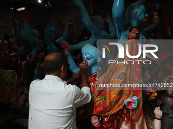 An artist paints an idol of the Hindu goddess Kali inside a workshop ahead of the Diwali festival in Kolkata, India, on October 27, 2024. Di...