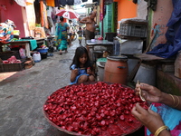 A girl colors earthen lamps, which are used to decorate temples and homes during the Hindu festival of Diwali, in Kolkata, India, on October...