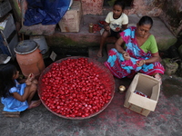 A woman and girls color earthen lamps, which are used to decorate temples and homes during the Hindu festival of Diwali, in Kolkata, India,...