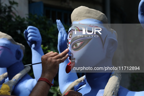 An artist paints an idol of the Hindu goddess Kali inside a workshop ahead of the Diwali festival in Kolkata, India, on October 27, 2024. Di...