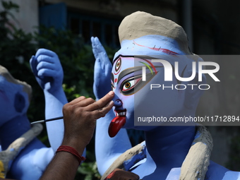 An artist paints an idol of the Hindu goddess Kali inside a workshop ahead of the Diwali festival in Kolkata, India, on October 27, 2024. Di...