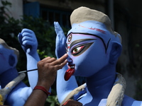 An artist paints an idol of the Hindu goddess Kali inside a workshop ahead of the Diwali festival in Kolkata, India, on October 27, 2024. Di...