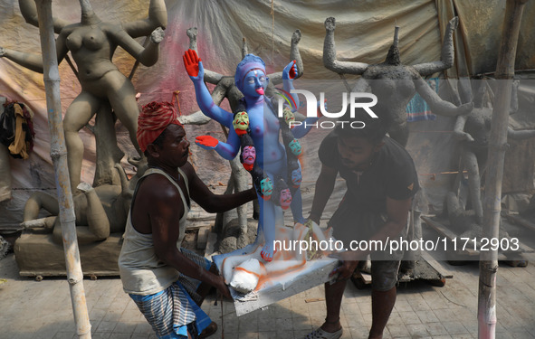 Workers carry an idol of the Hindu goddess Kali towards a workshop in Kolkata, India, on October 27, 2024. Diwali comes from the Sanskrit wo...