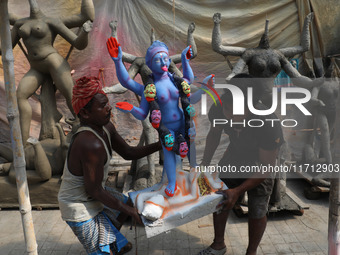 Workers carry an idol of the Hindu goddess Kali towards a workshop in Kolkata, India, on October 27, 2024. Diwali comes from the Sanskrit wo...