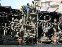 An artist works on an idol of the Hindu goddess Kali at a roadside workshop ahead of the Kali Puja festival and Diwali festival in Kolkata,...