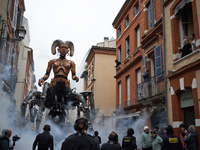 Lilith, the giant scorpion woman, is guided on one of the tiniest streets of Toulouse. French street show creator Francois Delaroziere, dire...