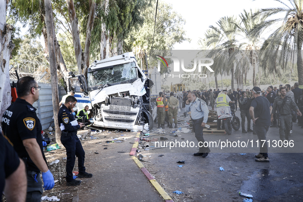 Medical and security teams respond to the scene where a truck crashed into a bus stop south of Tel Aviv, Israel, on October 27, 2024. The in...