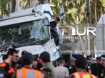 Medical and security teams respond to the scene where a truck crashed into a bus stop south of Tel Aviv, Israel, on October 27, 2024. The in...