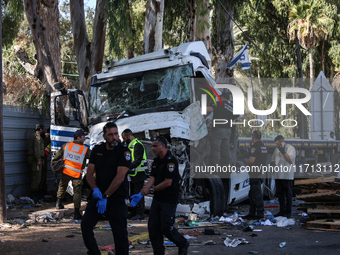 Medical and security teams respond to the scene where a truck crashed into a bus stop south of Tel Aviv, Israel, on October 27, 2024. The in...