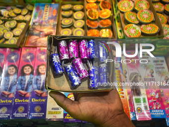 A person displays firecrackers for sale inside a firecracker market ahead of the Diwali festival in Kolkata, India, on October 27, 2024. (