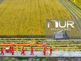 Villagers wave golden dragons in the fields to celebrate another harvest season in Qihu village, Huai'an city, Jiangsu province, China, on O...