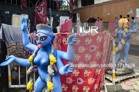 An idol maker paints an idol of the Hindu goddess Kali ahead of the Kali Puja festival in Kolkata, India, on October 27, 2024. 