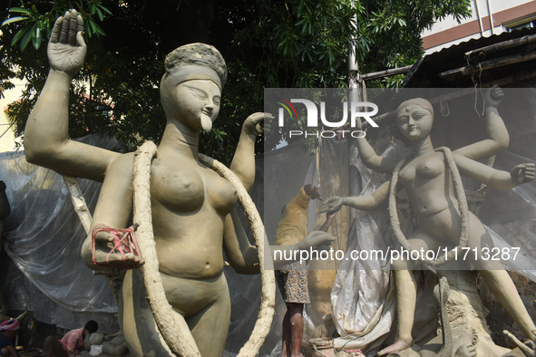 An idol maker creates an idol of the Hindu goddess Kali ahead of the Kali Puja festival in Kolkata, India, on October 27, 2024. 