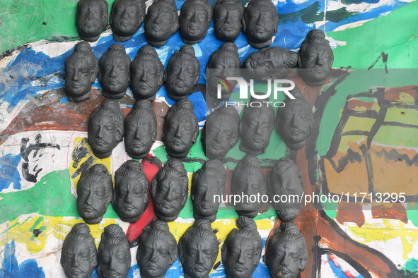 Half-made faces of Ashura dry in the sun at a roadside workshop ahead of the Kali Puja festival in Kolkata, India, on October 27, 2024. 