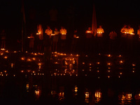 Priests, along with residents of Siliguri, illuminate earthen lamps on the riverbank of the Mahananda in Siliguri, India, on October 27, 202...