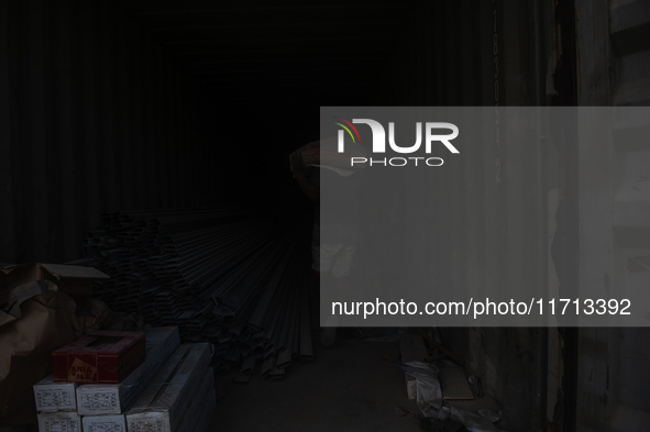 Porters load sacks of cement at the port of Belawan for the USU Residence III housing complex in Patumbak, Deli Serdang, North Sumatra, on O...