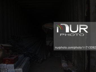 Porters load sacks of cement at the port of Belawan for the USU Residence III housing complex in Patumbak, Deli Serdang, North Sumatra, on O...