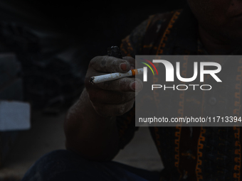 Porters rest after loading sacks of cement at the port of Belawan for the USU Residence III housing complex in Patumbak, Deli Serdang, North...