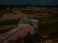 Porters load sacks of cement at the port of Belawan for the USU Residence III housing complex in Patumbak, Deli Serdang, North Sumatra, on O...