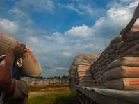 Porters load sacks of cement at the port of Belawan for the USU Residence III housing complex in Patumbak, Deli Serdang, North Sumatra, on O...