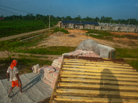 Porters load sacks of cement at the port of Belawan for the USU Residence III housing complex in Patumbak, Deli Serdang, North Sumatra, on O...