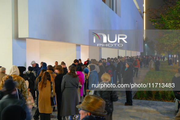 People wait in line outside the new Museum of Modern Art (Muzeum Sztuki Nowoczesnej) in Warsaw, Poland on 25 October, 2024. 