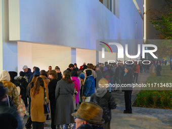 People wait in line outside the new Museum of Modern Art (Muzeum Sztuki Nowoczesnej) in Warsaw, Poland on 25 October, 2024. (