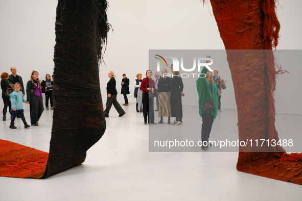 Visitors observe a sculpture by Magdalena Abakanowicz at the new Museum of Modern Art (Muzeum Sztuki Nowoczesnej) in Warsaw, Poland on 25 Oc...