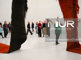 Visitors observe a sculpture by Magdalena Abakanowicz at the new Museum of Modern Art (Muzeum Sztuki Nowoczesnej) in Warsaw, Poland on 25 Oc...