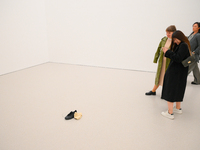 Visitors take a photo of a shoe and a hat on the floor of the new Museum of Modern Art (Muzeum Sztuki Nowoczesnej) in Warsaw, Poland on 25 O...