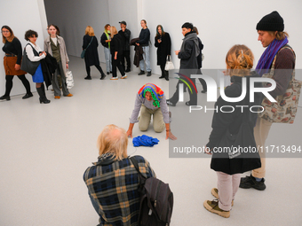 An elderly man performs while people watch at the opening of the new Museum of Modern Art (Muzeum Sztuki Nowoczesnej) in Warsaw, Poland on 2...