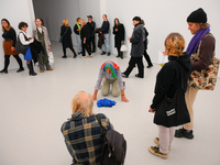 An elderly man performs while people watch at the opening of the new Museum of Modern Art (Muzeum Sztuki Nowoczesnej) in Warsaw, Poland on 2...