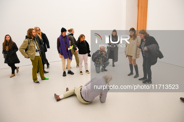 An elderly man performs while people watch at the opening of the new Museum of Modern Art (Muzeum Sztuki Nowoczesnej) in Warsaw, Poland on 2...