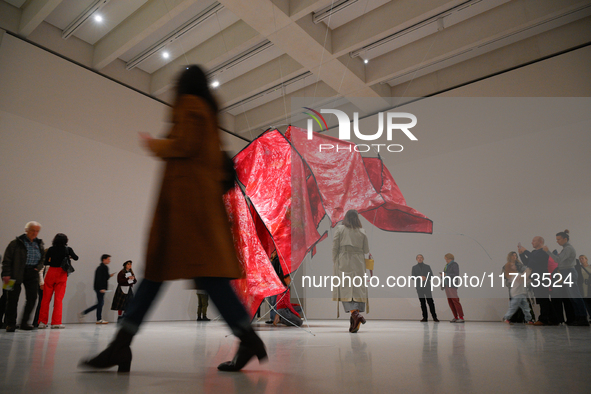 Visitors observe the sculpture ''Ghosting'' by Congolese artist Sandra Mujinga at the opening of the new Museum of Modern Art (Muzeum Sztuki...