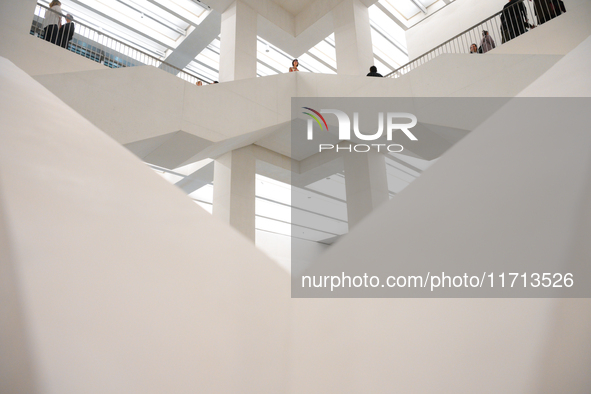 Visitors are seen on the evening of the opening of the new Museum of Modern Art (Muzeum Sztuki Nowoczesnej) in Warsaw, Poland on 25 October,...