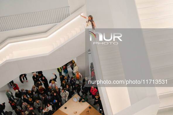 Visitors are seen on the evening of the opening of the new Museum of Modern Art (Muzeum Sztuki Nowoczesnej) in Warsaw, Poland on 25 October,...