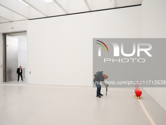 A photographer is seen at the opening of the new Museum of Modern Art (Muzeum Sztuki Nowoczesnej) in Warsaw, Poland on 25 October, 2024. (