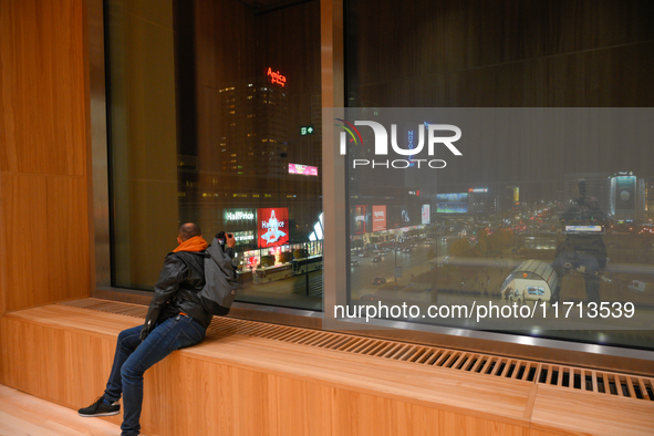 A man looks out a window of the new Museum of Modern Art (Muzeum Sztuki Nowoczesnej) in Warsaw, Poland on 25 October, 2024. 