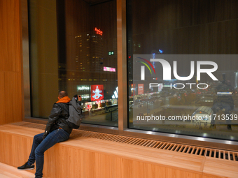 A man looks out a window of the new Museum of Modern Art (Muzeum Sztuki Nowoczesnej) in Warsaw, Poland on 25 October, 2024. (