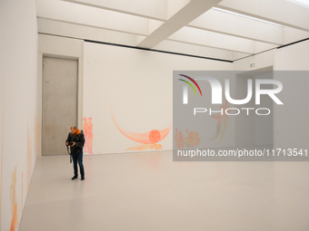 A photographer is seen at the opening of the new Museum of Modern Art (Muzeum Sztuki Nowoczesnej) in Warsaw, Poland on 25 October, 2024. (