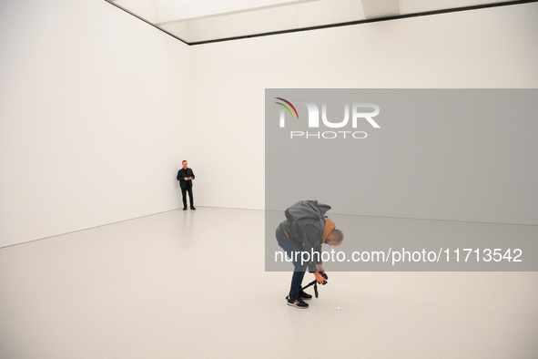 A photographer is seen at the opening of the new Museum of Modern Art (Muzeum Sztuki Nowoczesnej) in Warsaw, Poland on 25 October, 2024. 