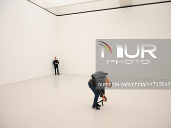 A photographer is seen at the opening of the new Museum of Modern Art (Muzeum Sztuki Nowoczesnej) in Warsaw, Poland on 25 October, 2024. (