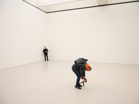 A photographer is seen at the opening of the new Museum of Modern Art (Muzeum Sztuki Nowoczesnej) in Warsaw, Poland on 25 October, 2024. (